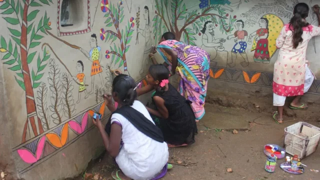 Jharkhand village walls depicting tribal life by madhubani morals