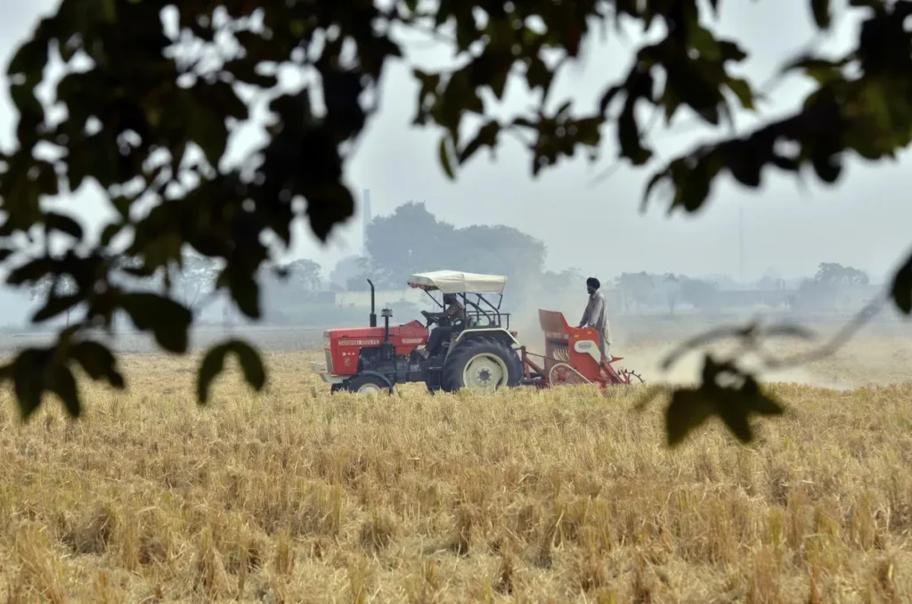 Agriculture in India tractor farming Punjab preparing field for a wheat crop without burning previous crop stalk