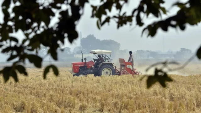Agriculture in India tractor farming Punjab preparing field for a wheat crop without burning previous crop stalk