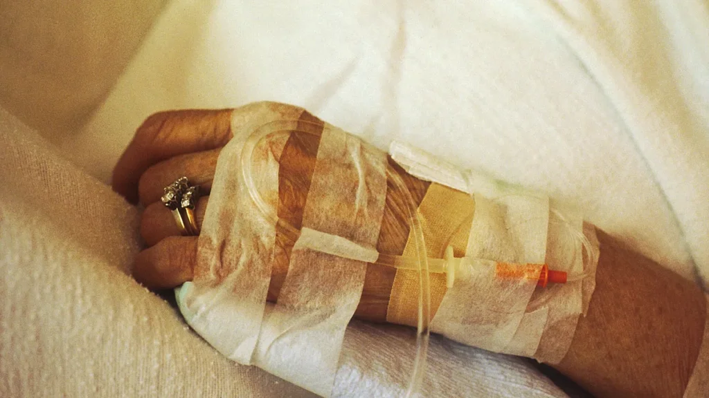 Close-up of a chemotherapy drip line taped to a cancer patient's hand
