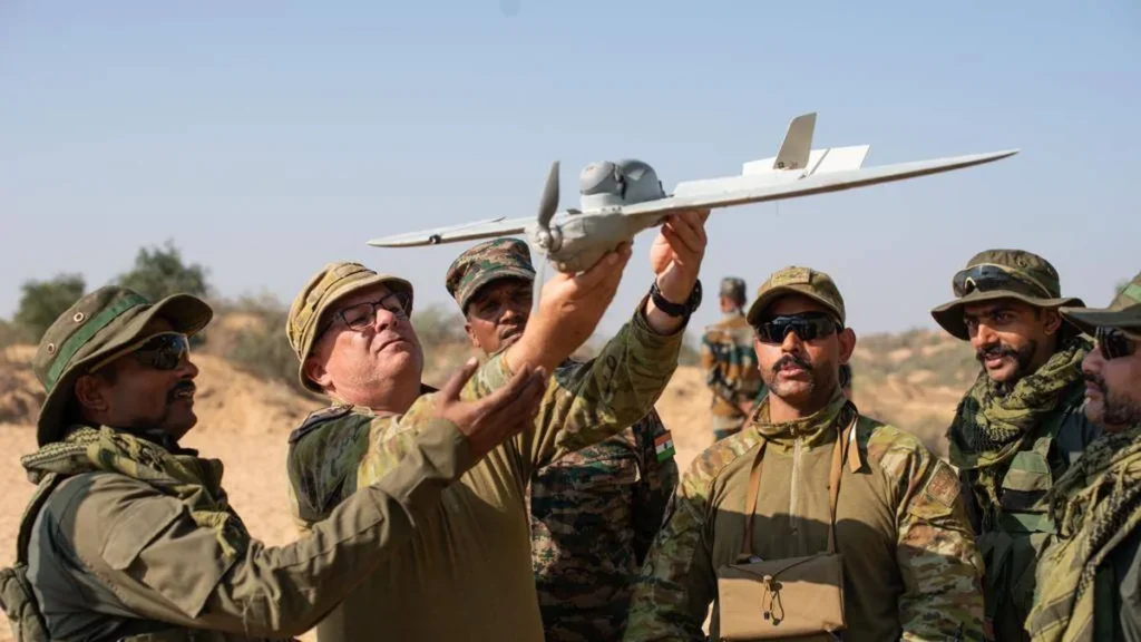 Indian and Australian soldiers handling a drone during AustraHind