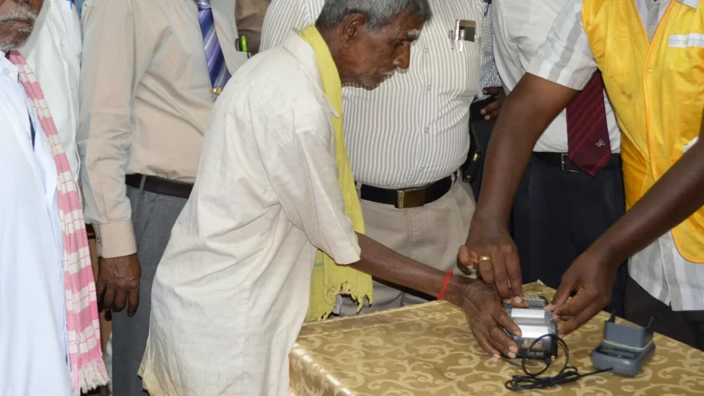 Villager using a micro-ATM with fingerprint authentication
