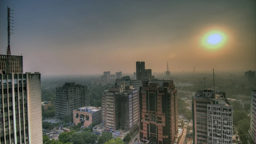 Smog hanging over Delhi buildings at sunset