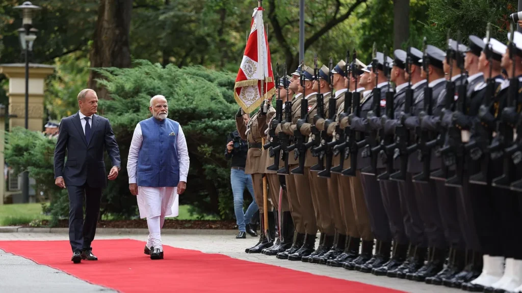 Narendra Modi and Donald Tusk walk past a guard of honour in Warsaw