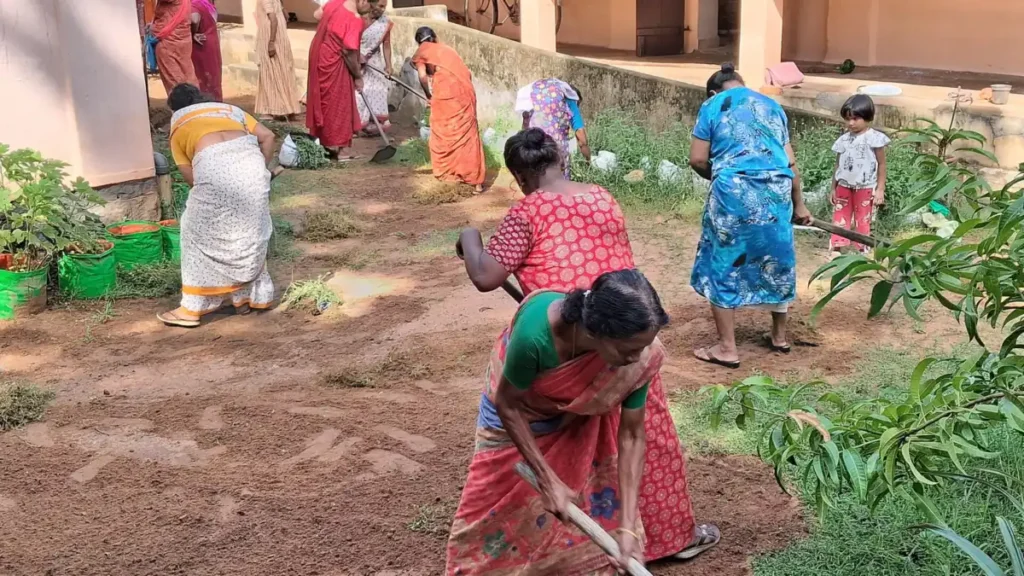 Women workers clearing land at a rural employment scheme worksite in Kollam, Kerala