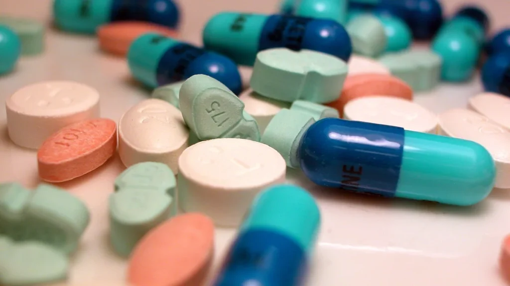 Assorted tablets and capsules scattered on a table