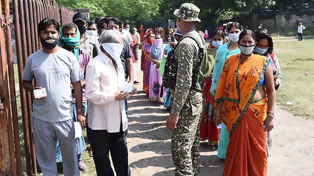 Voters standing in a queue at a polling booth in Gaya, Bihar