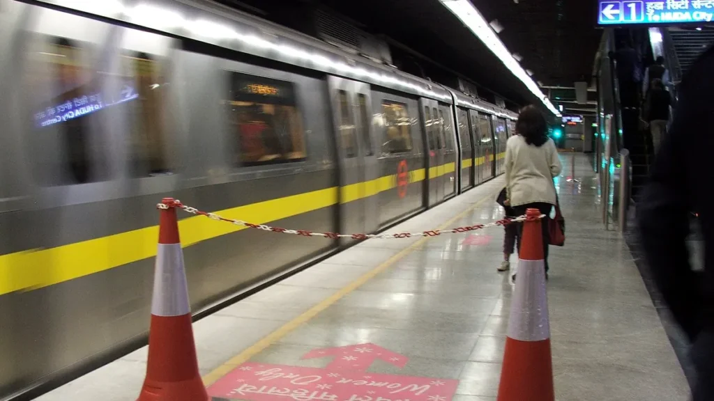 A woman waiting at the women-only boarding area of a Delhi Metro platform
