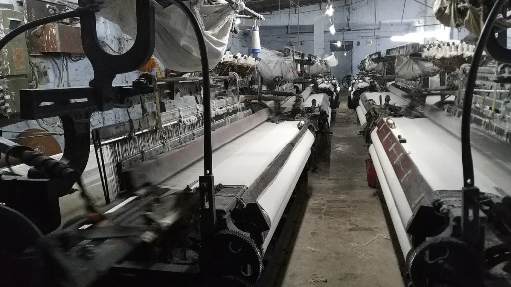 Rows of power looms weaving white cloth in a textile unit in Meerut, Uttar Pradesh