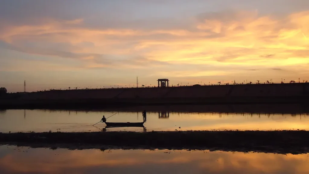 Fishermen spreading a net on the Gomti river, Lucknow