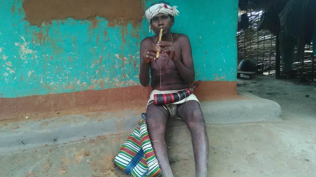 Dhurwa man playing flute