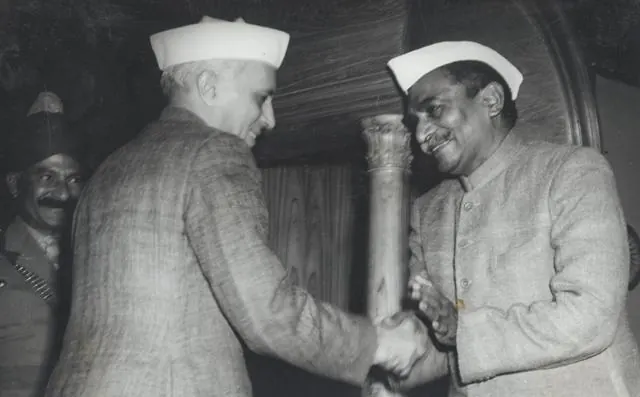 Rajendra Prasad shakes hands with Nehru after signing the Constitution, January 1950