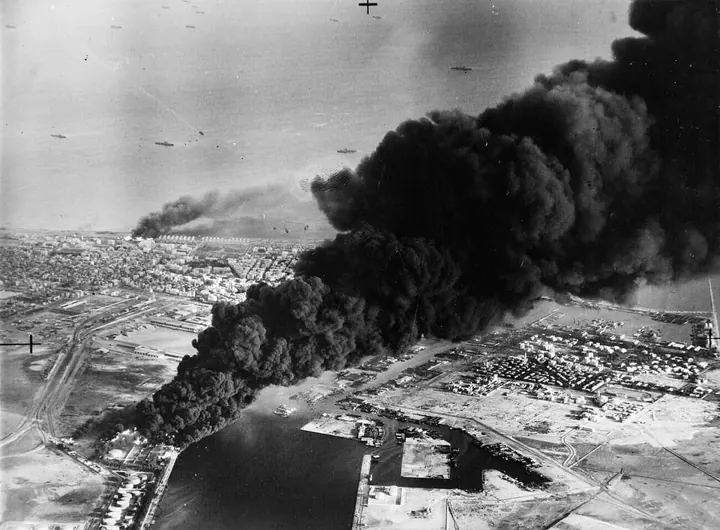 Smoke rises from oil tanks at Port Said during the Anglo-French assault, 5 November 1956