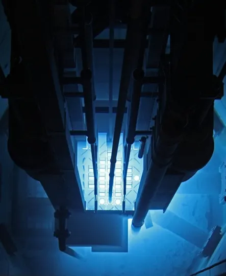 The blue Cherenkov glow around a research reactor core in its water pool
